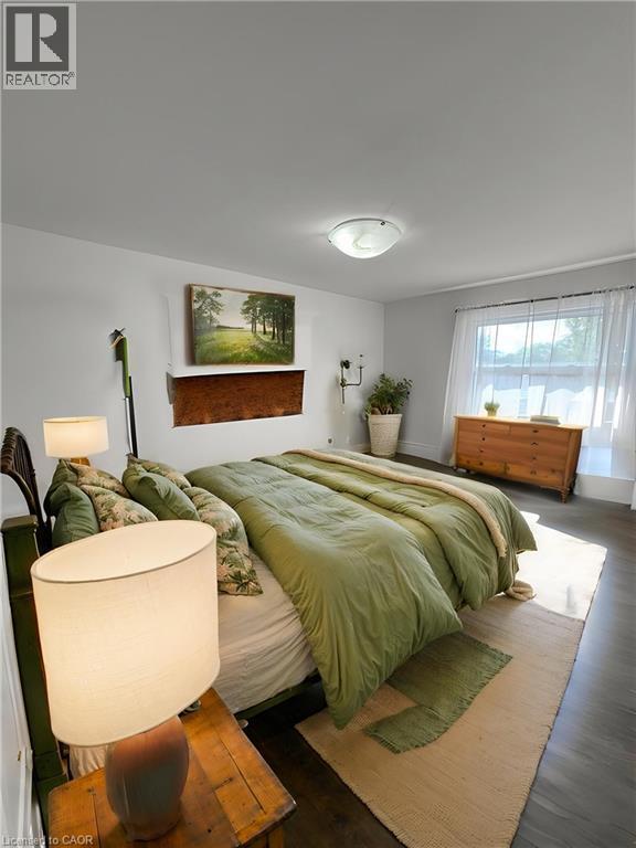 Spacious room featuring dark wood-finish flooring and light-toned walls **Virtually Staged** - 148 Bishop Street S, Cambridge, ON