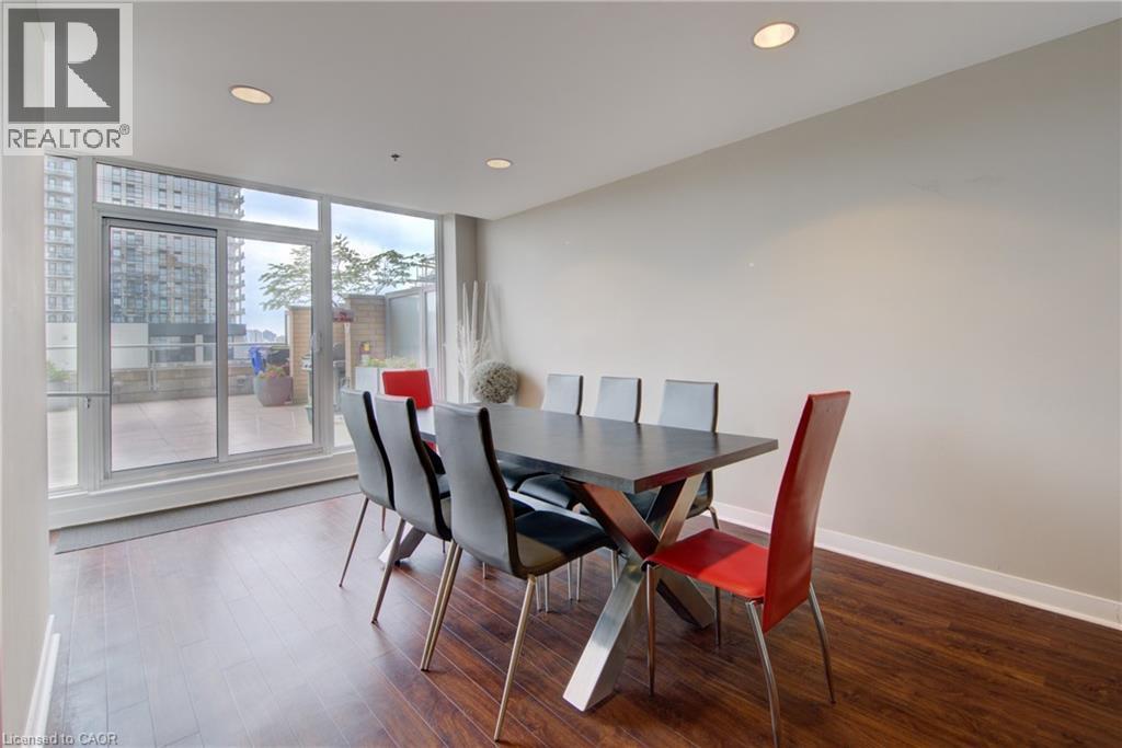 Building Party Room ,Dining space featuring rich wood-finish flooring and recessed lighting - 191 King Street S Unit# 607, Waterloo, ON