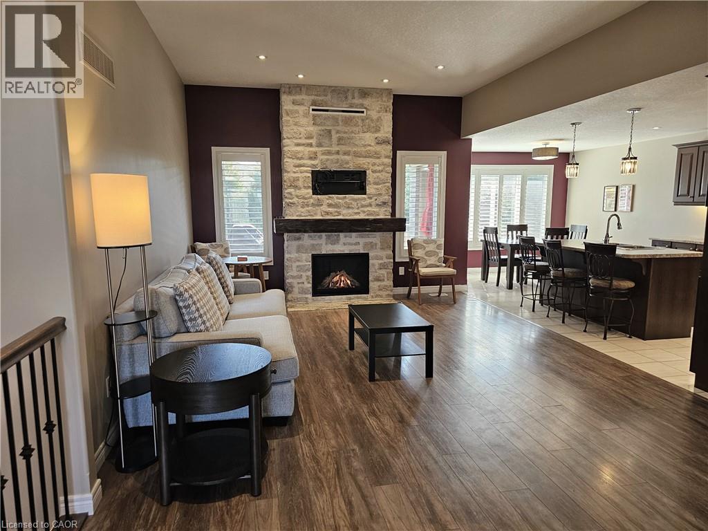 Open-concept layout - 98 Allandale Crescent, Simcoe, ON - Indoor Photo Showing Living Room With Fireplace