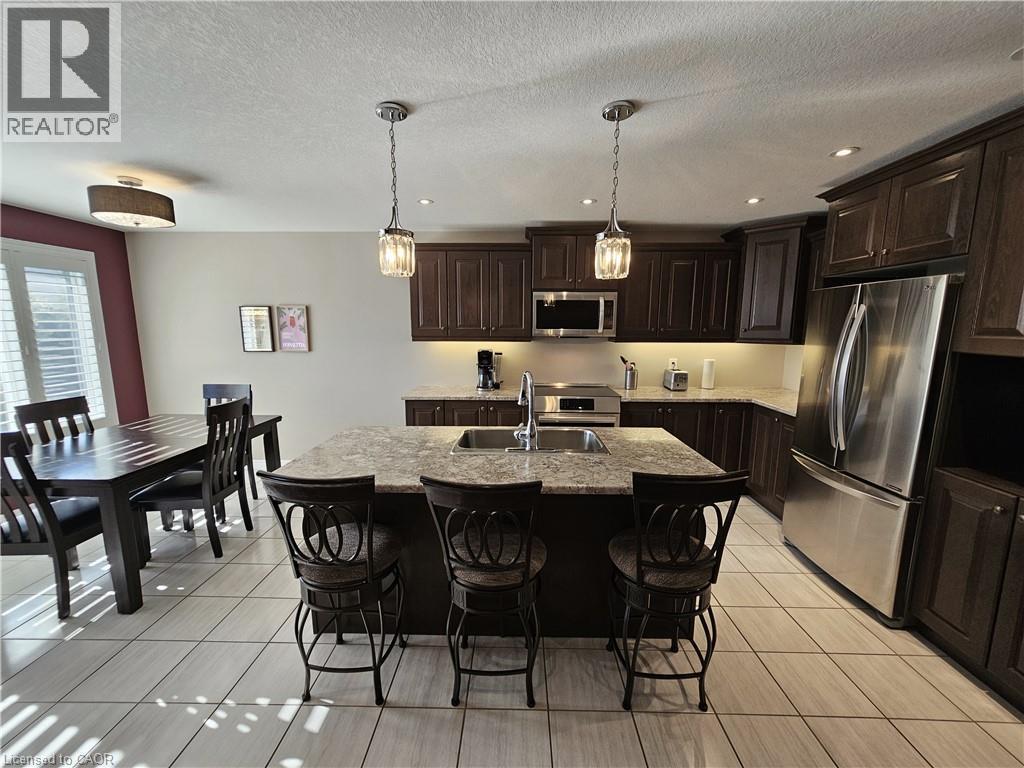 Island featuring a double sink and built-in dishwasher - 98 Allandale Crescent, Simcoe, ON - Indoor