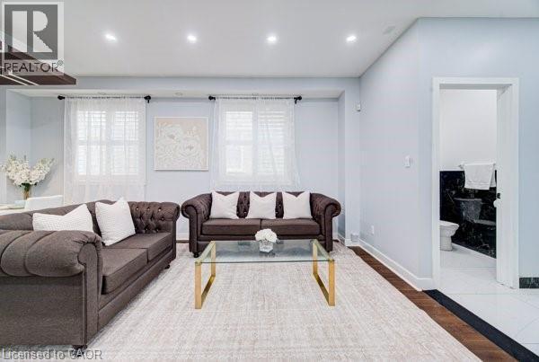 Bright living area featuring recessed lighting and light blue wall paint - 55 Isaiah Drive, Kitchener, ON