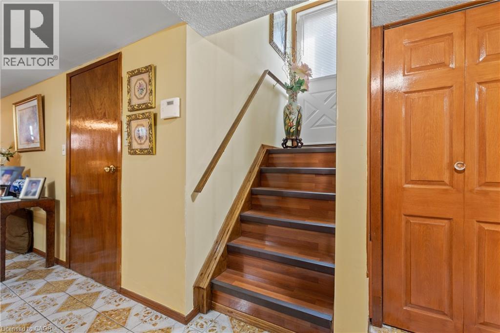 Hardwood staircase with integrated treads. - 202 Ray Street N, Hamilton, ON - Indoor Photo Showing Other Room