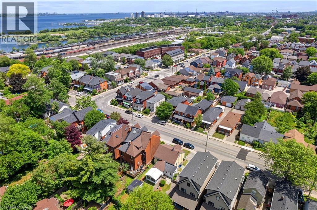 Aerial perspective showcasing a residential area with diverse architectural styles, mature trees, and paved streets - 193 Locke Street N, Hamilton, ON - Outdoor With View