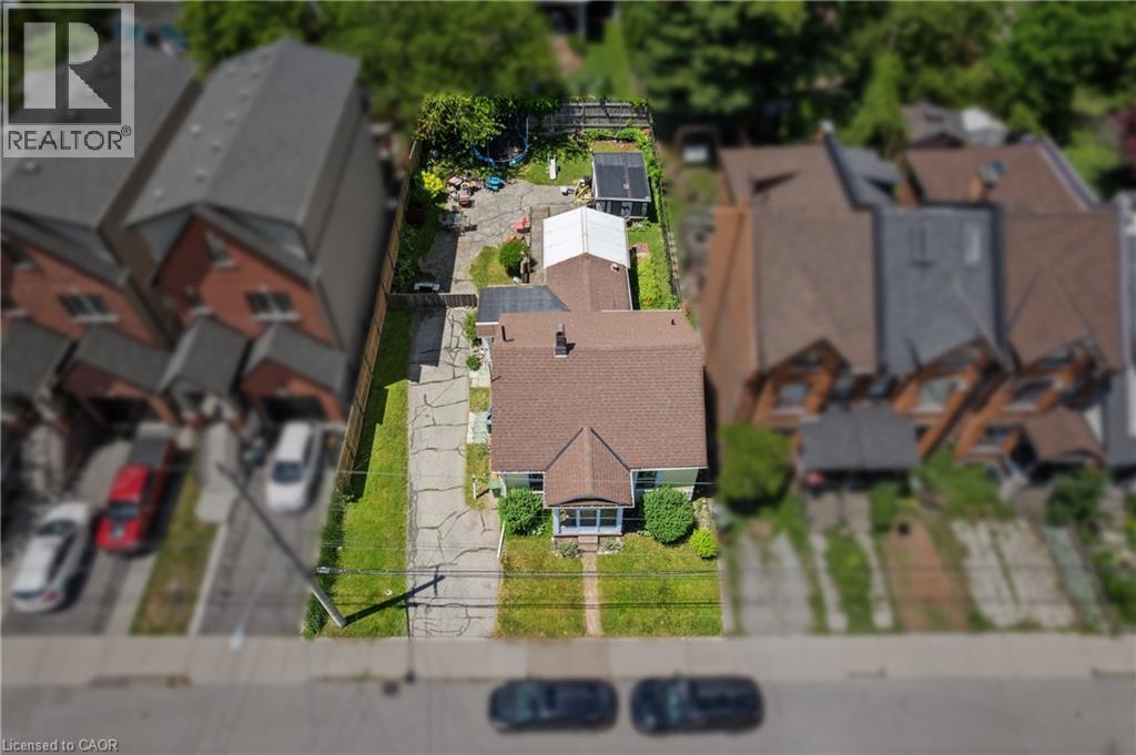 Aerial perspective showcasing a detached residence with a prominent gabled roofline and light-colored siding. - 193 Locke Street N, Hamilton, ON - Outdoor With View
