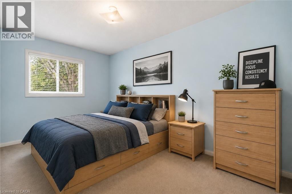 VIRTUALLY STAGED Light-filled room featuring a single window with blinds, a built-in bed frame with storage drawers, a coordinating nightstand, and a five-drawer dresser - 4413 Peter Drive, Burlington, ON
