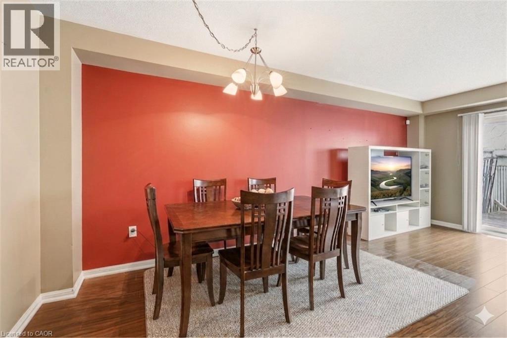 Wood-finish flooring throughout, complemented by a light area rug - 4413 Peter Drive, Burlington, ON