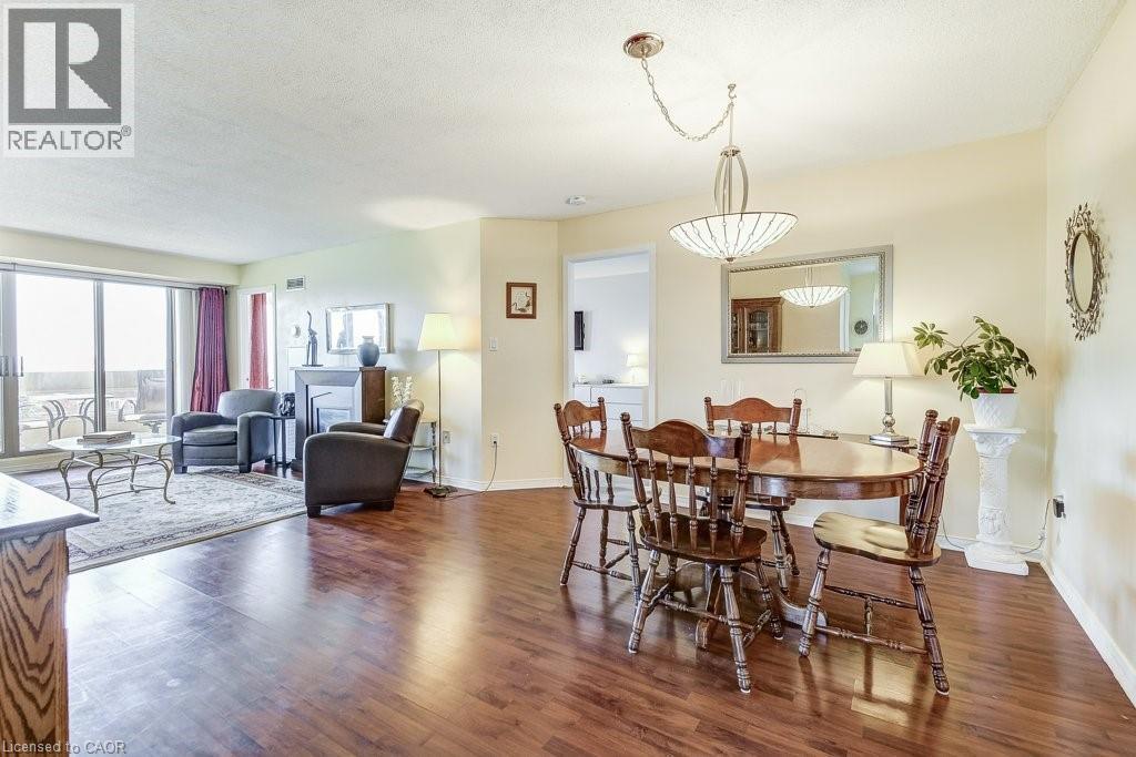 Open concept living and dining area featuring wood-finish flooring - 1201 North Shore Boulevard E Unit# 706, Burlington, ON - Indoor