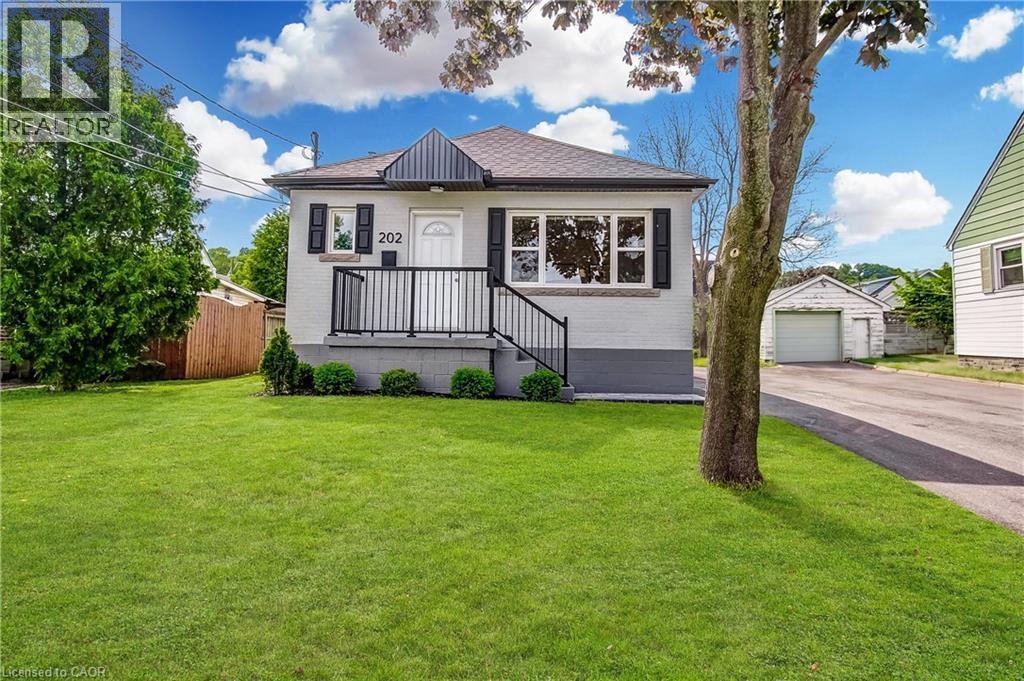 Single-story residence featuring a light-colored brick exterior and dark accent trim - 202 Erindale Avenue, Hamilton, ON