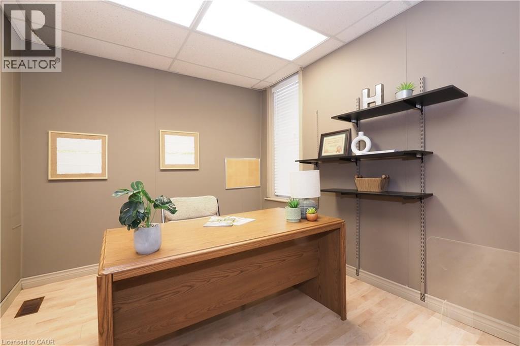 Recessed lighting, wood-finish flooring, a window with blinds, and built-in adjustable shelving - 731 King Street E, Cambridge, ON