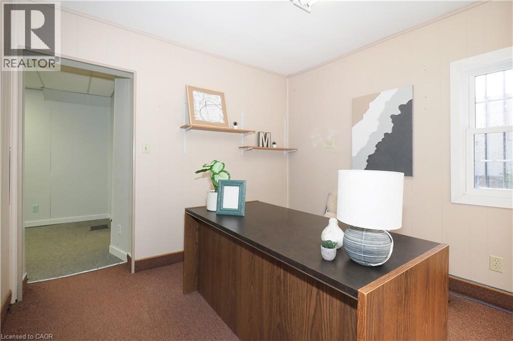 Carpeted room with light-colored paneled walls and a built-in window - 731 King Street E, Cambridge, ON