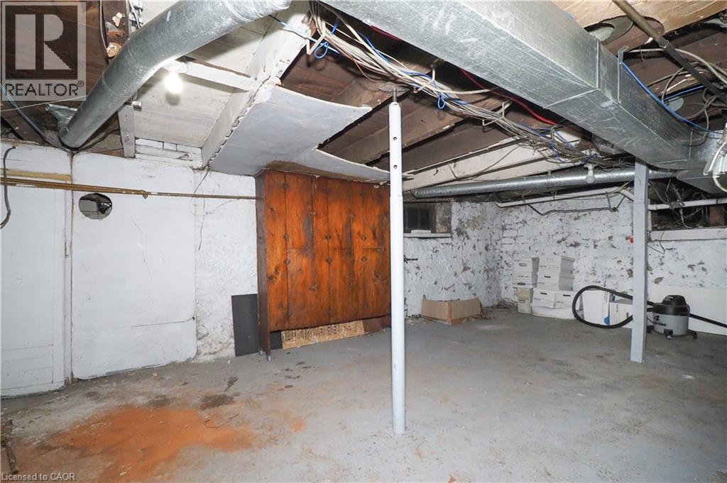 Concrete flooring with exposed ceiling joists and ductwork - 731 King Street E, Cambridge, ON