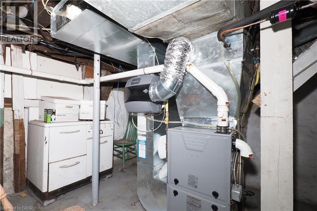 Utility area featuring a furnace system with associated ductwork and piping - 731 King Street E, Cambridge, ON