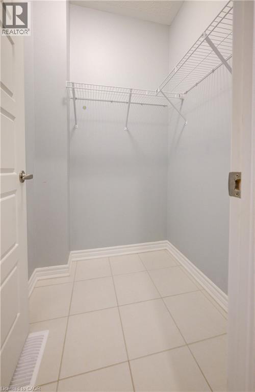 Walk in closet featuring light tile patterned floors - 302 Jean Landing, Milton, ON