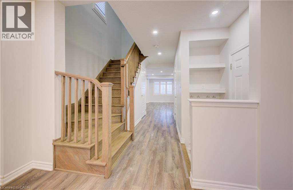 Hallway with light wood finished floors and recessed lighting - 302 Jean Landing, Milton, ON