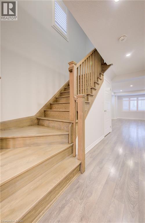 Stairway featuring hardwood / wood-style flooring and recessed lighting - 302 Jean Landing, Milton, ON