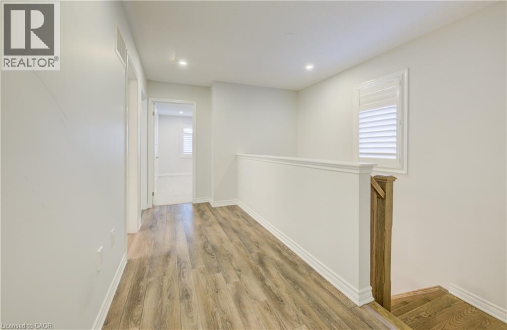 Corridor featuring an upstairs landing, light wood-style floors, and recessed lighting - 302 Jean Landing, Milton, ON