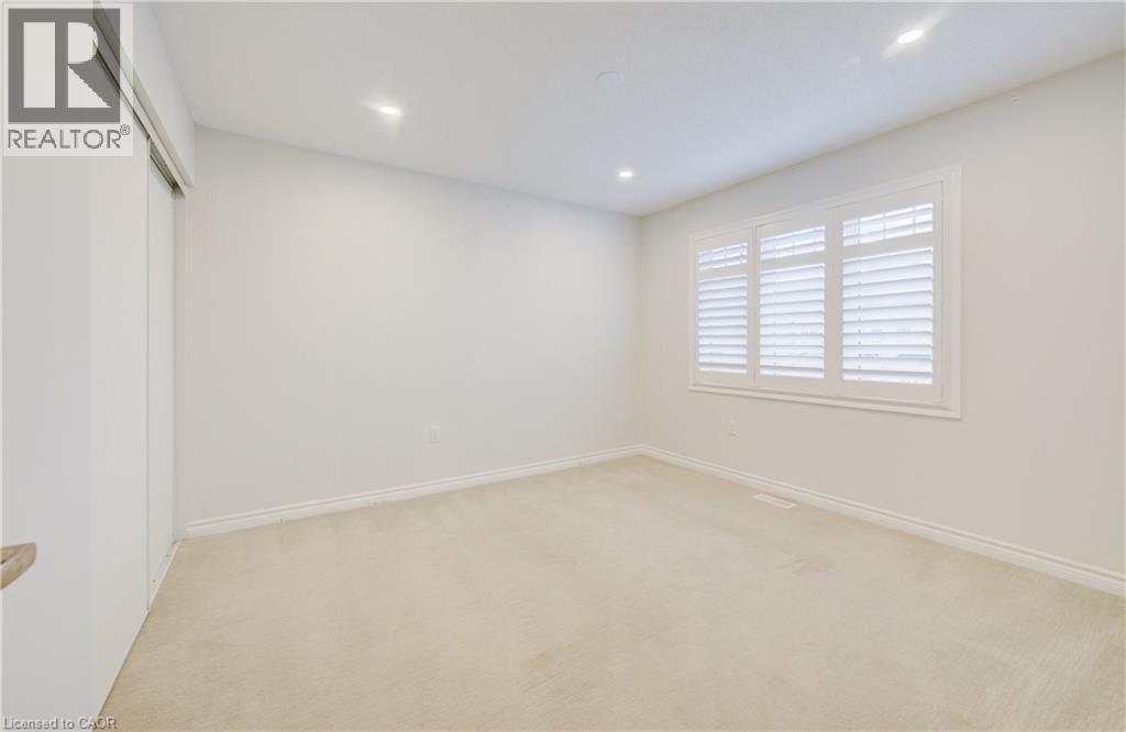 Unfurnished bedroom with light carpet, recessed lighting, and a closet - 302 Jean Landing, Milton, ON