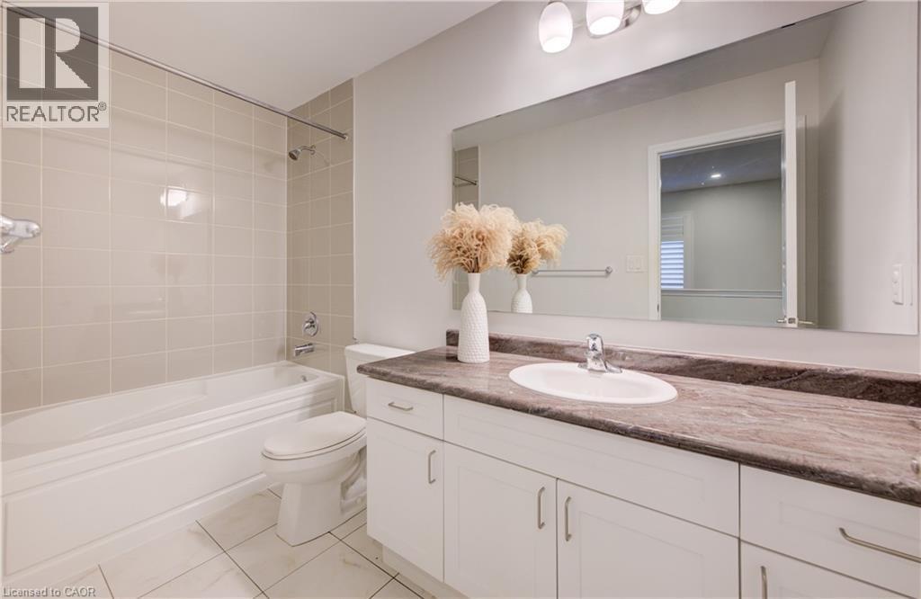 Full bathroom with vanity, shower / bath combination, and light tile patterned floors - 302 Jean Landing, Milton, ON