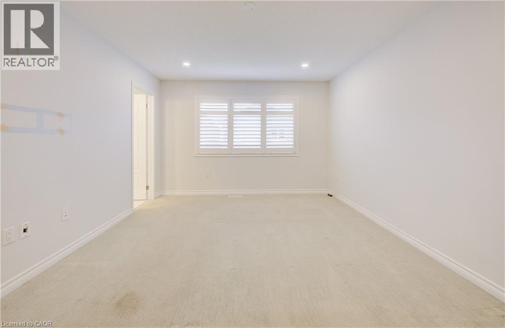 Spare room featuring light carpet and recessed lighting - 302 Jean Landing, Milton, ON