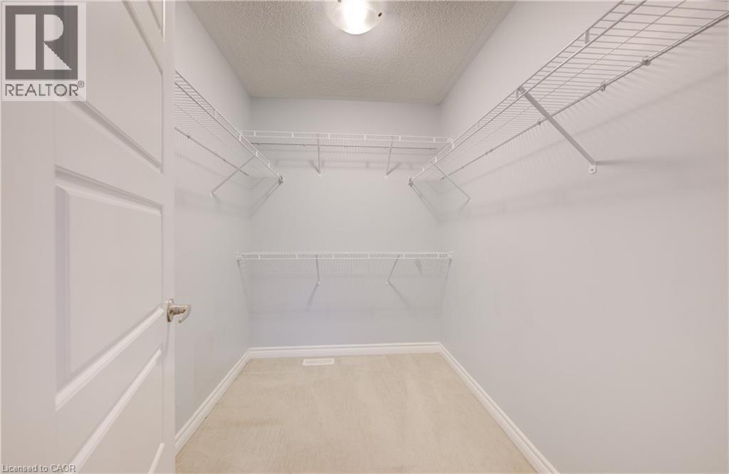 Walk in closet featuring light carpet - 302 Jean Landing, Milton, ON
