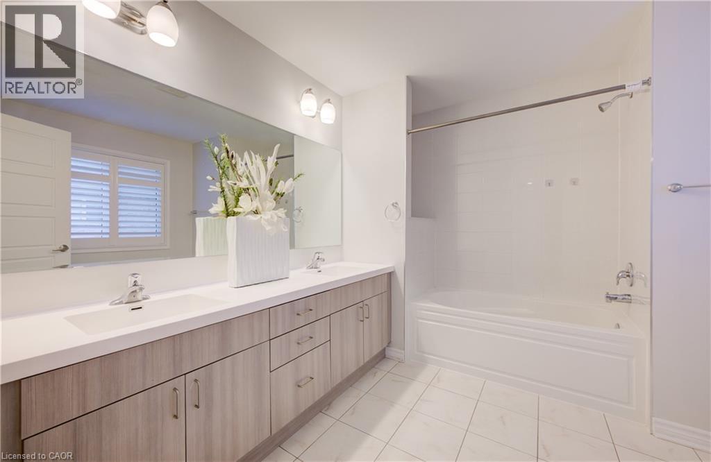 Bathroom with double vanity and tub / shower combination - 302 Jean Landing, Milton, ON