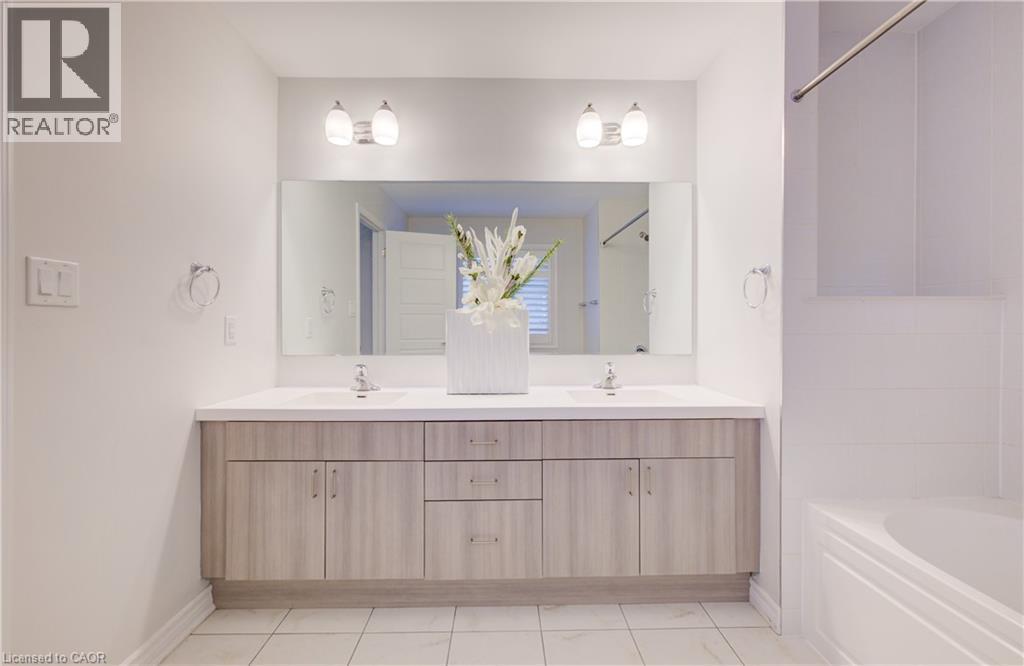 Bathroom with double vanity, shower combination, and light tile patterned floors - 302 Jean Landing, Milton, ON