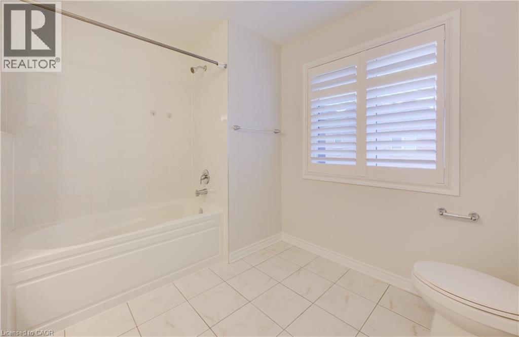 Bathroom with shower / bath combination and light tile patterned floors - 302 Jean Landing, Milton, ON