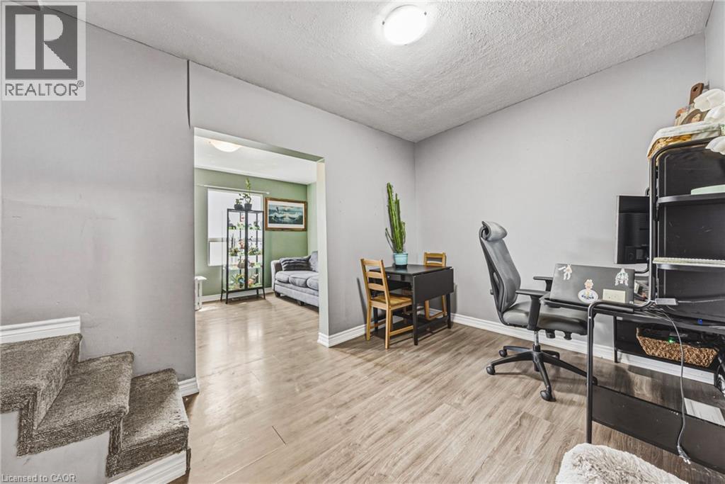 Open concept room featuring wood-finish flooring and a neutral color palette - 47 Fraser Avenue, Hamilton, ON