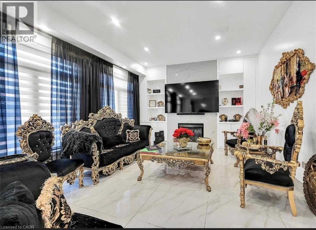 Living area featuring white tile flooring, recessed lighting, and expansive windows with sheer and solid privacy treatments - 137 Diiorio Circle, Ancaster, ON