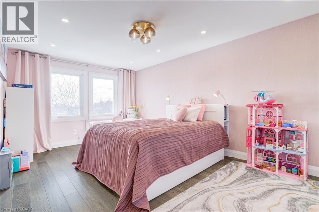 Bedroom featuring dark wood-finish flooring and light pink textured wallpaper - 1320 Monmouth Drive, Burlington, ON