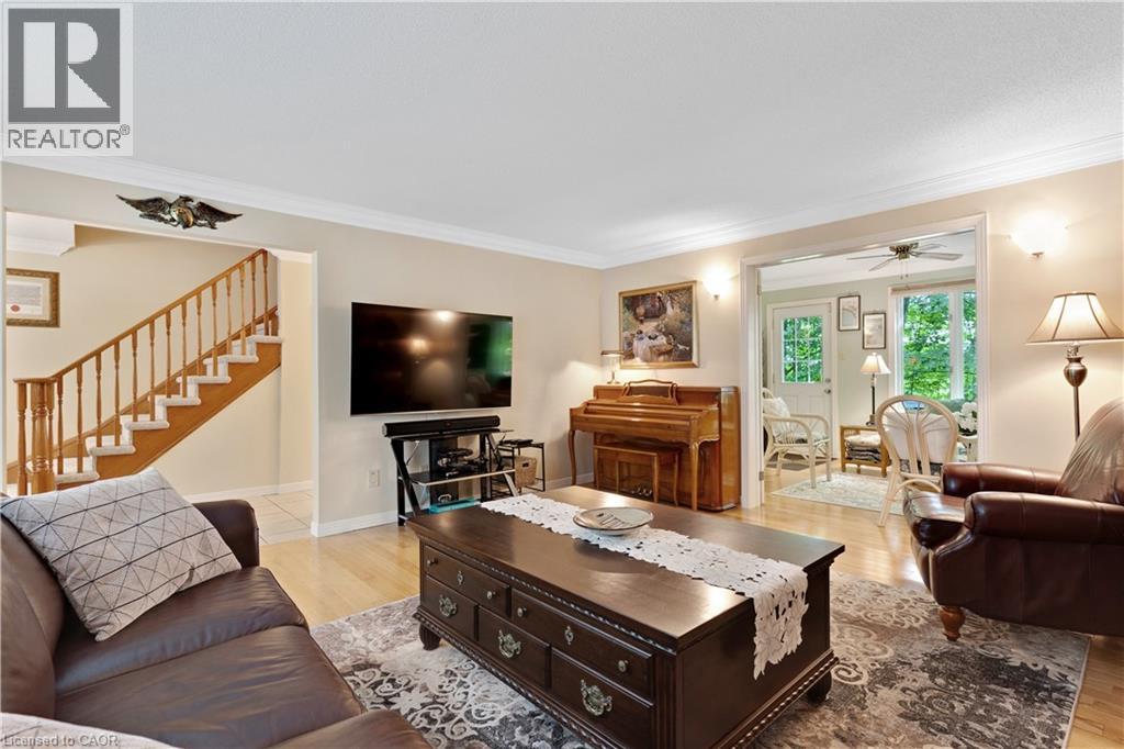 Bright living space featuring wood-finish flooring and crown molding - 110 Grand Ridge Drive, Cambridge, ON