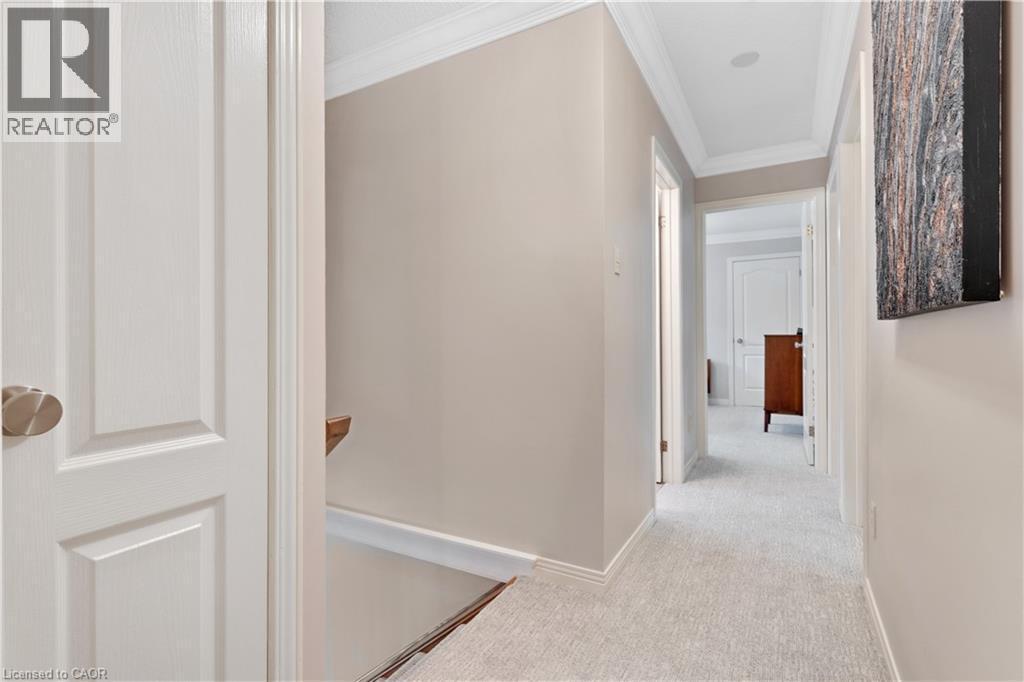 Hallway featuring light neutral wall paint, white trim, crown molding, light-colored carpeting, and recessed lighting - 110 Grand Ridge Drive, Cambridge, ON