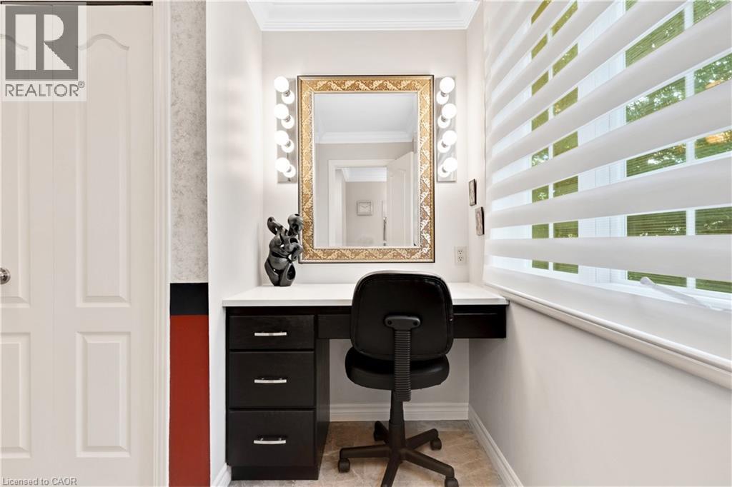 Built-in vanity with a white countertop and dark wood-finish cabinetry - 110 Grand Ridge Drive, Cambridge, ON