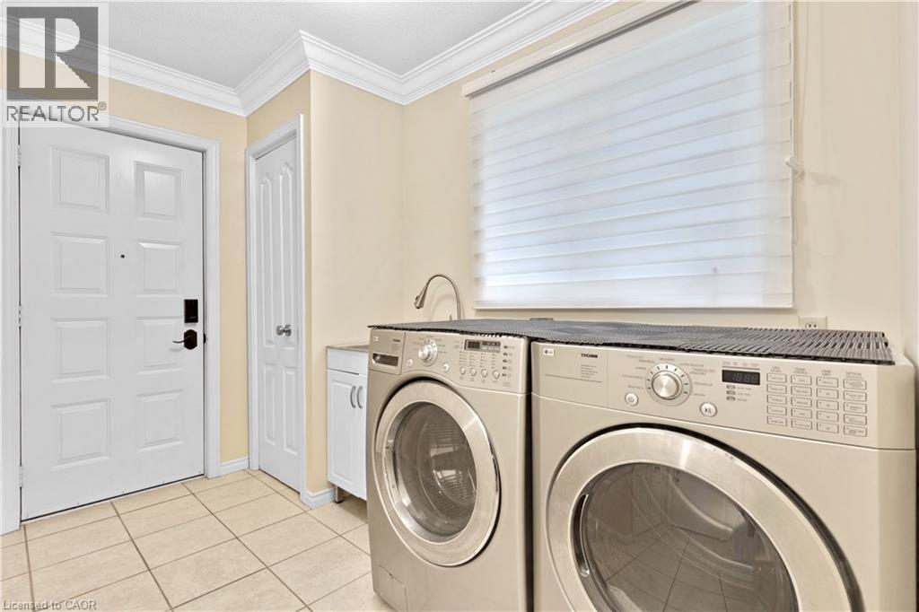 Utility area featuring tile flooring, white crown molding, a window with horizontal blinds, and a built-in sink with a gooseneck faucet - 110 Grand Ridge Drive, Cambridge, ON