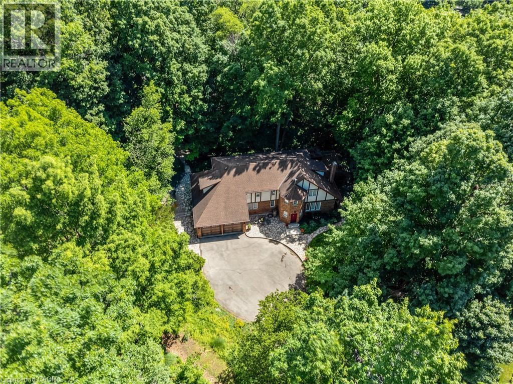Brick and timber-frame residence set within dense tree coverage - 110 Grand Ridge Drive, Cambridge, ON