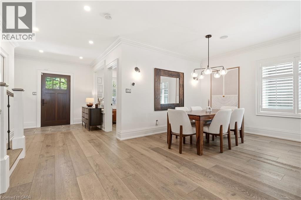 Open concept living space featuring light wood-finish flooring, recessed lighting, and white walls with crown molding - 336 Newbold Court, Burlington, ON