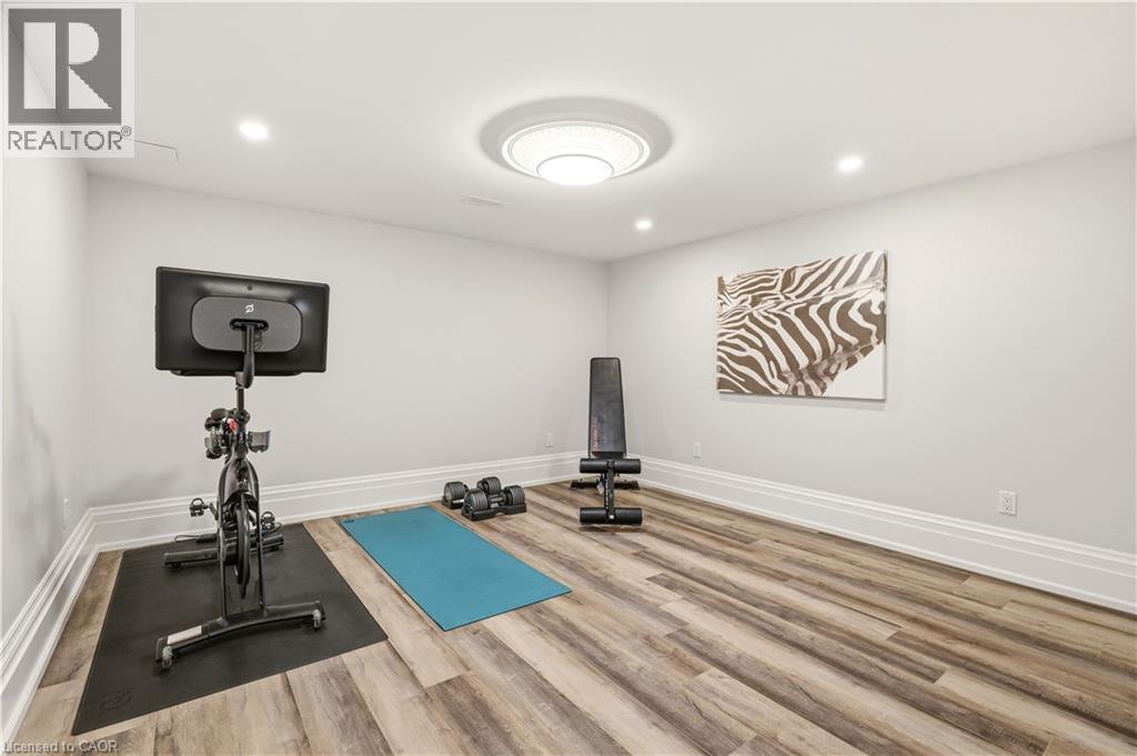 Recessed lighting illuminating a spacious room with wood-finish flooring - 336 Newbold Court, Burlington, ON