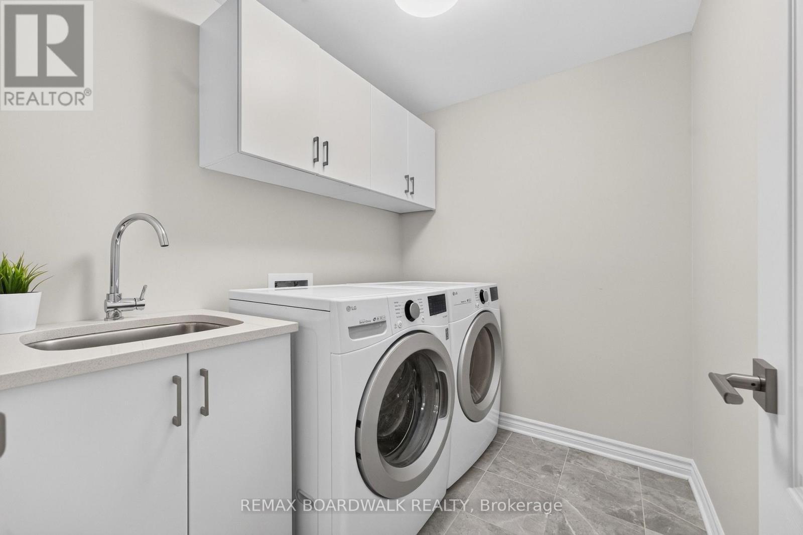 Laundry Room w/Built in Cabinets & Sink + Storage - 224 Maygrass Way, Ottawa, ON - Indoor Photo Showing Laundry Room