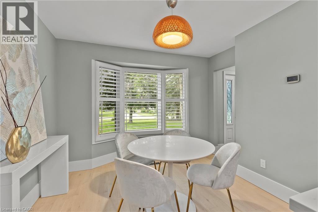 Bay window with plantation shutters and a view of exterior greenery - 44 Fireside Drive, Hamilton, ON