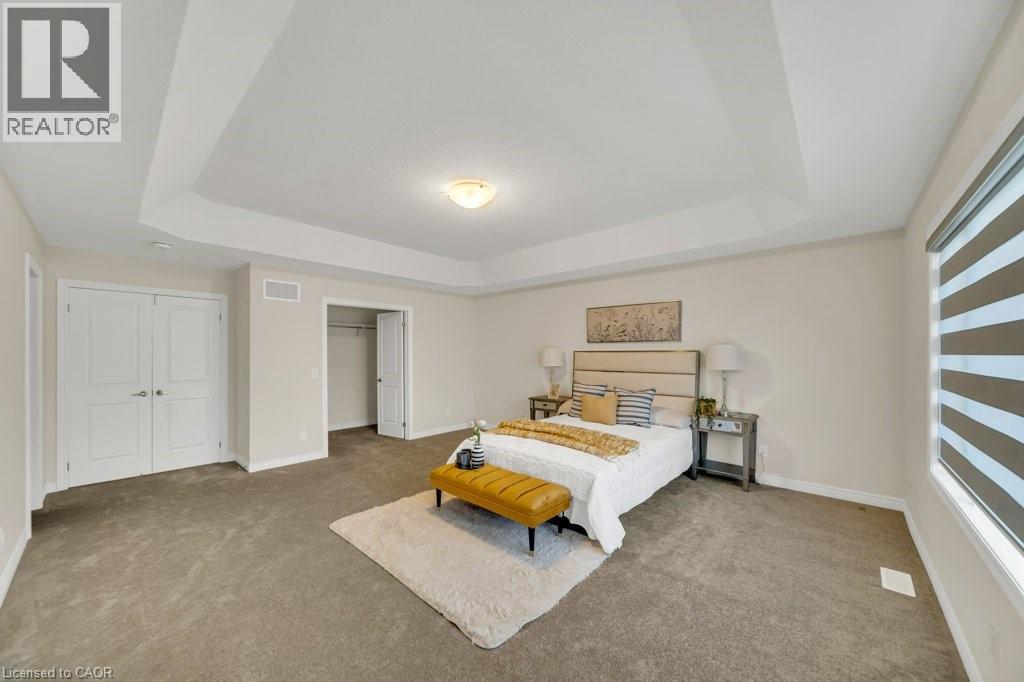 Bedroom featuring a raised ceiling and carpet - 285 Broadacre Drive, Kitchener, ON