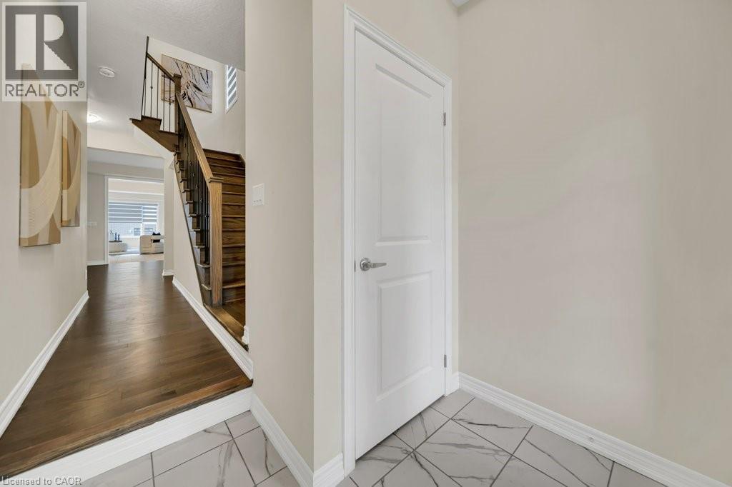 Hallway featuring stairs and light marble finish floors - 285 Broadacre Drive, Kitchener, ON