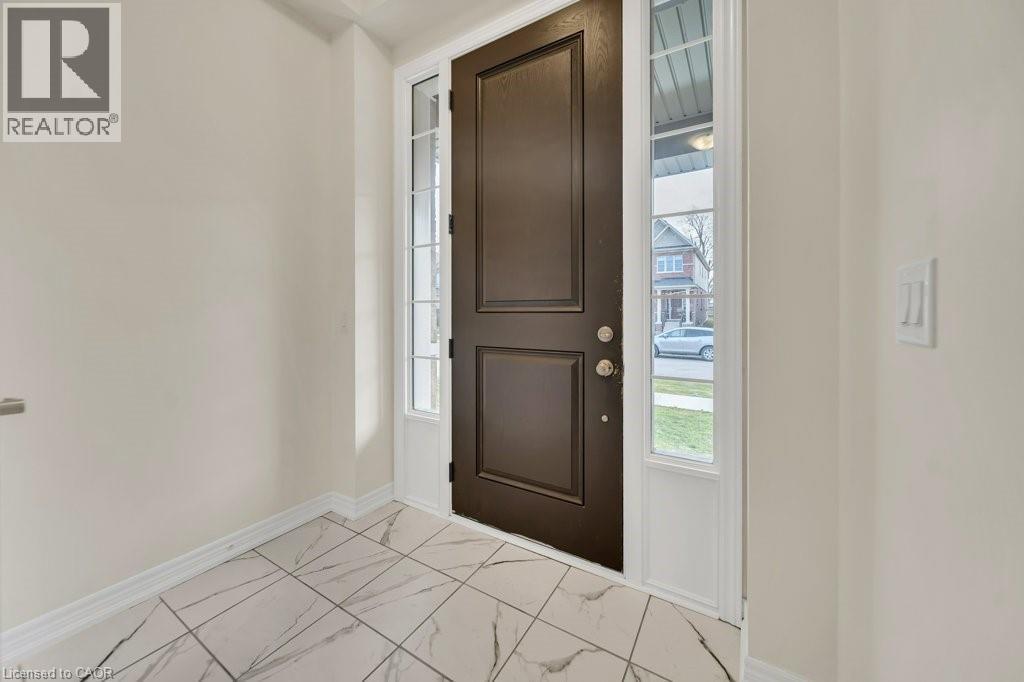 Entryway with light marble finish flooring and plenty of natural light - 285 Broadacre Drive, Kitchener, ON