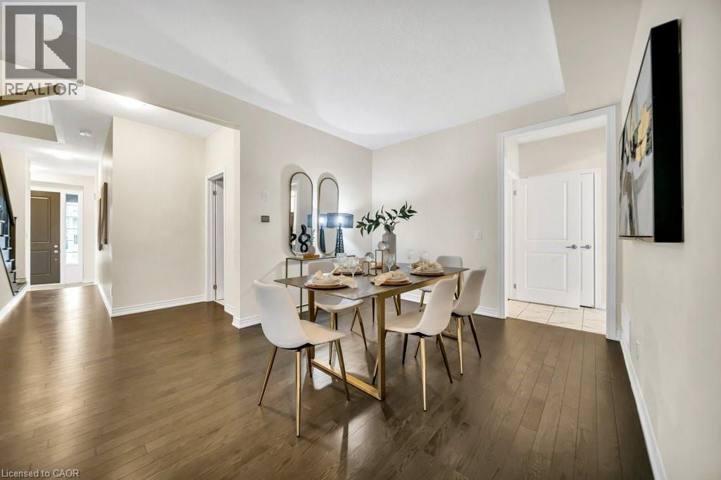 Dining room featuring dark wood-type flooring and stairs - 285 Broadacre Drive, Kitchener, ON