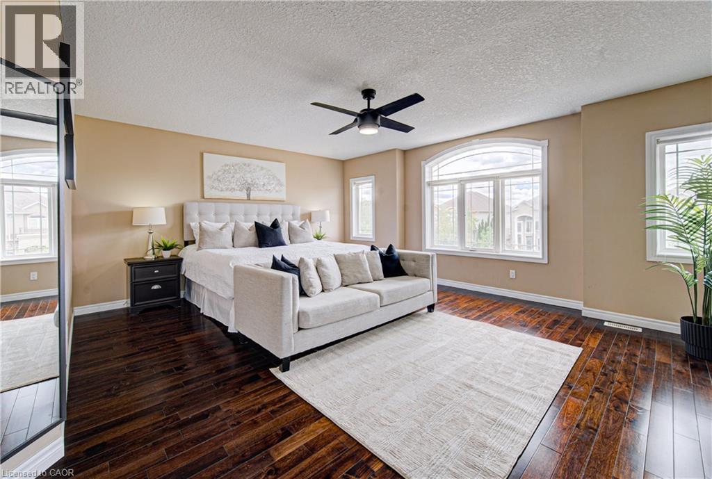 Spacious room featuring rich wood-finish flooring and a neutral color palette - 37 Davinci Boulevard, Hamilton, ON