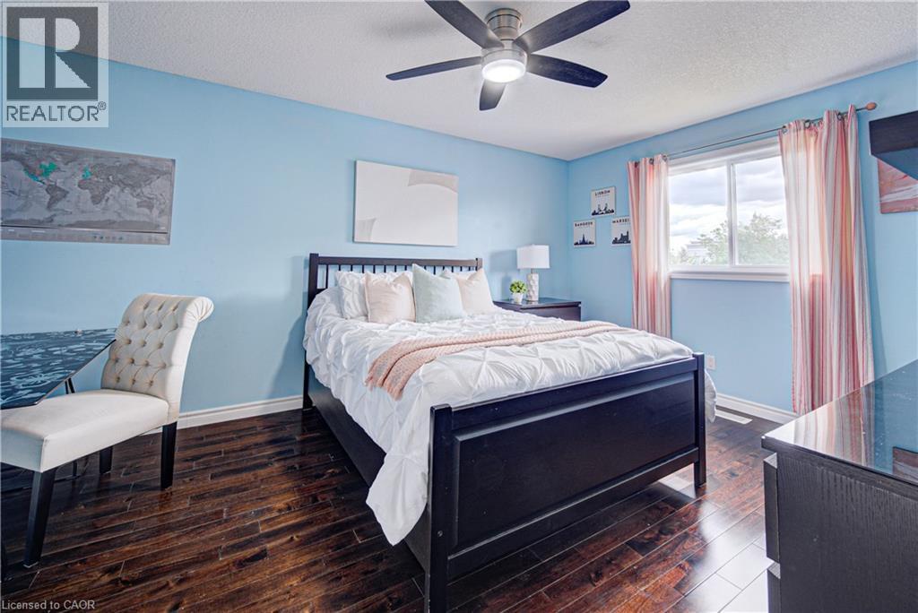 Room featuring rich, dark wood-finish flooring, light blue walls, and a ceiling fan with integrated lighting - 37 Davinci Boulevard, Hamilton, ON