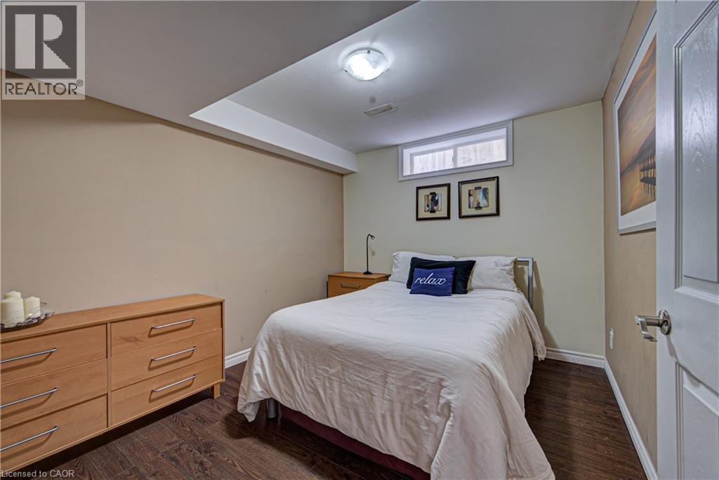 Bedroom featuring wood-finish flooring and a light-colored wall palette - 37 Davinci Boulevard, Hamilton, ON
