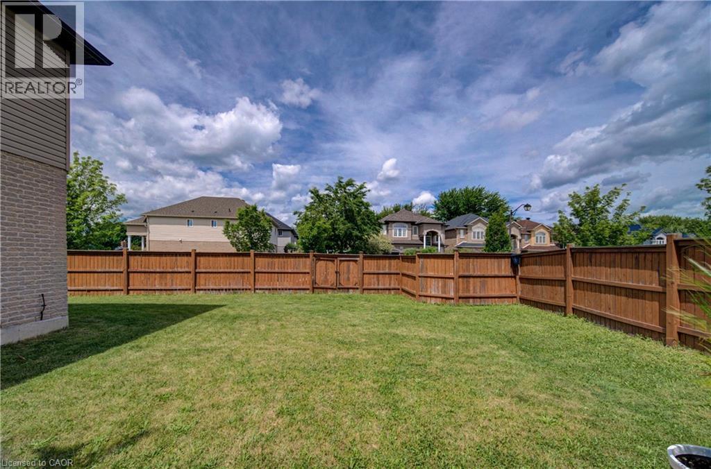 Spacious grass lawn with a full wood privacy fence - 37 Davinci Boulevard, Hamilton, ON