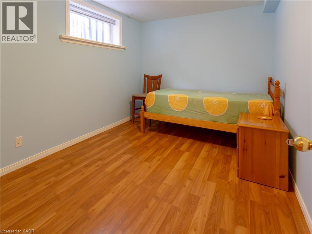 Laundry area featuring a front-loading washing machine, top-loading dryer, and a utility sink - 212 Sleaford Street, Waterloo, ON