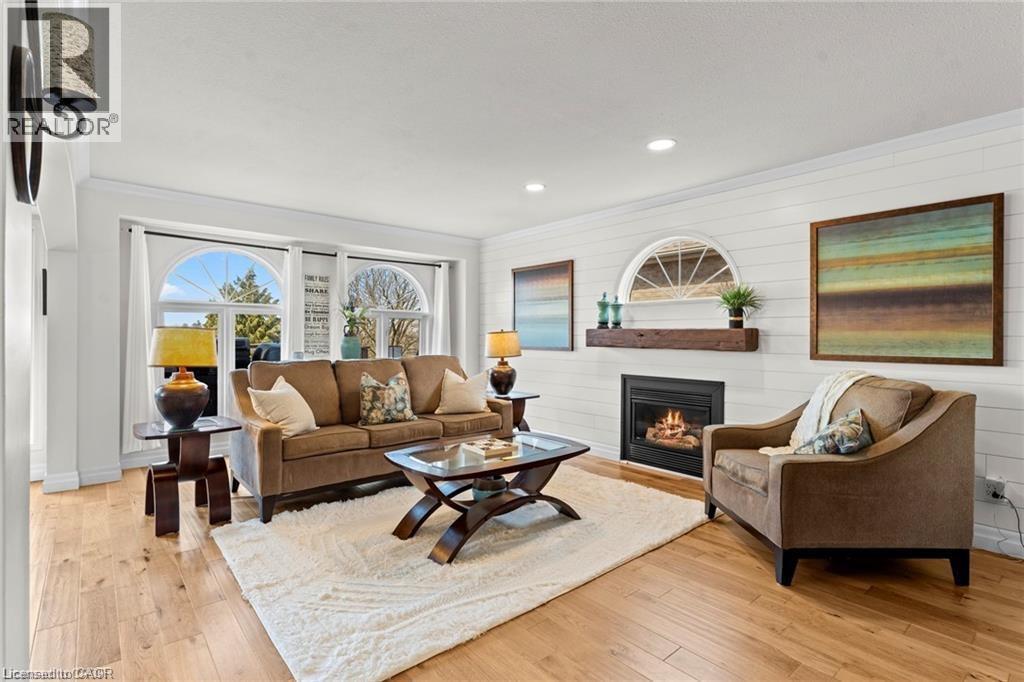 Hardwood-finish flooring complements white shiplap walls - 26 Shadyridge Place, Kitchener, ON