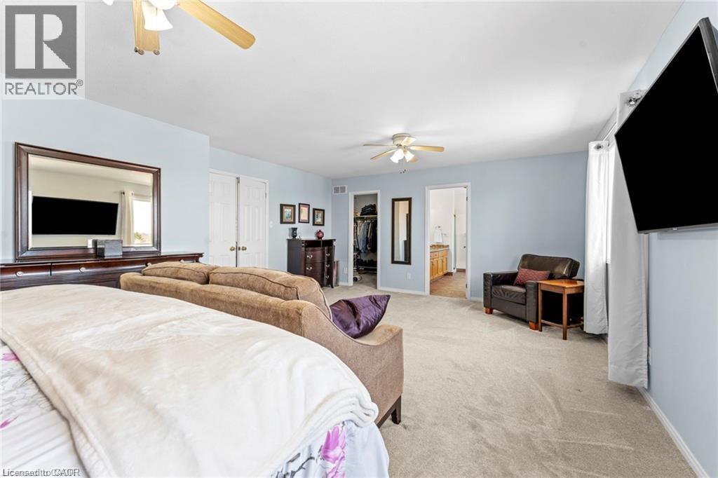 Spacious room with light blue walls and neutral carpet flooring - 26 Shadyridge Place, Kitchener, ON